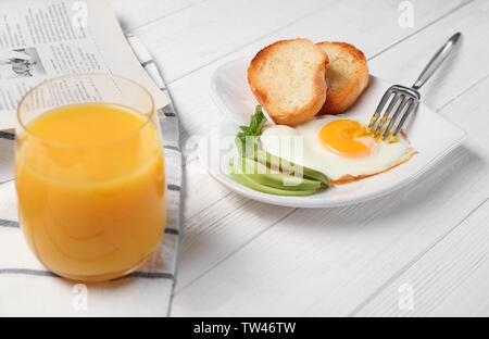 Delicious over easy egg with toasts and avocado on kitchen table Stock Photo