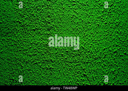 Brightly lit surface covered with bright green plaster. Trend color Stock Photo