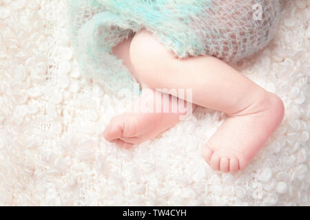 Newborn baby boy lying on soft plaid at home Stock Photo