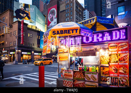 USA, New York, Manhattan. May 3, 2019. Broadway streets at night. Take away fast food kiosk, illuminated selling hot dog Stock Photo