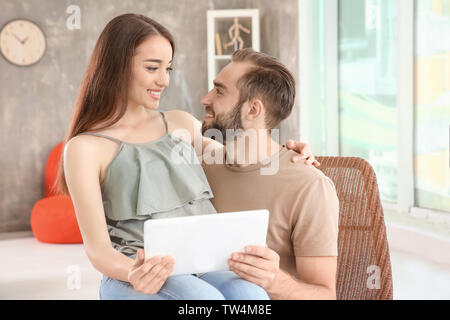 Young couple searching information using tablet at home Stock Photo
