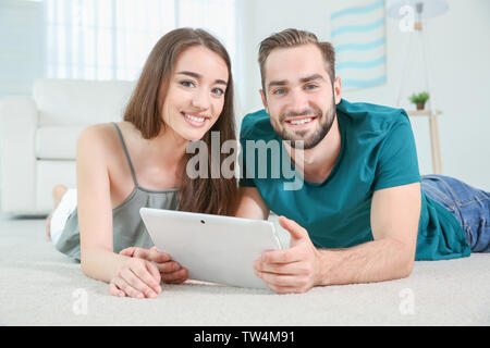 Young couple searching information using tablet at home Stock Photo