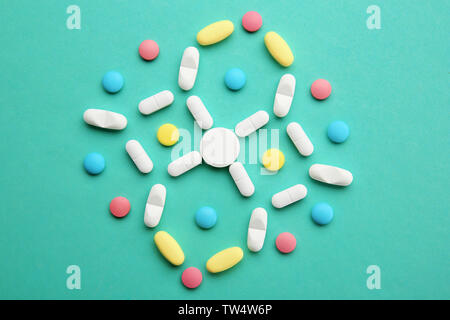 Composition with different pills on color background Stock Photo