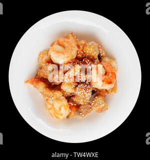 Deep fried eggplant and shrimps in sweet-sour sauce, isolated on black Stock Photo