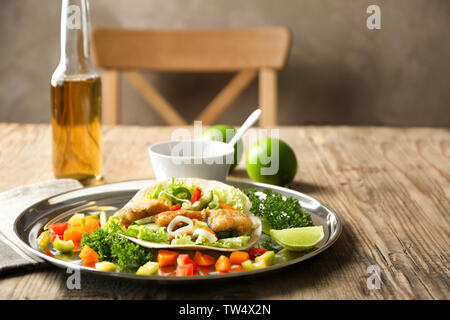 Tray with delicious fish taco on wooden table Stock Photo