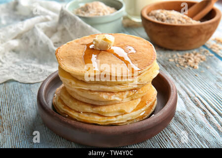 Plate with tasty pancakes on wooden table Stock Photo