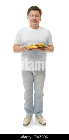 Overweight man holding plate with junk food on white background. Weight loss concept Stock Photo