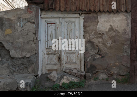 old crumbling door in a stone house Stock Photo