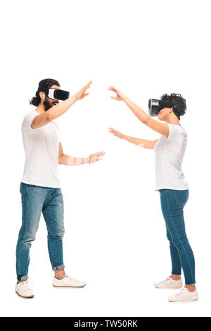 bearded latin man and woman wearing virtual reality headsets and gesturing isolated on white Stock Photo