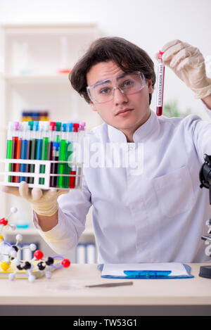 Young male biochemist working in the lab Stock Photo
