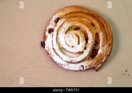 Buns with raisins on wood texture background. Stock Photo