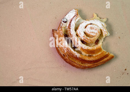Piece of muffin with raisins on wood texture background. Stock Photo