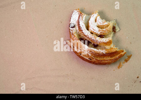 Piece of muffin with raisins on wood texture background. Stock Photo