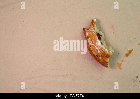 Piece of muffin with raisins on wood texture background. Stock Photo