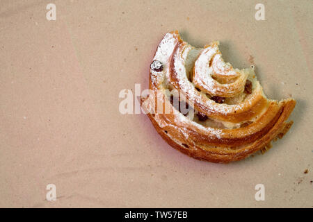 Piece of muffin with raisins on wood texture background. Stock Photo
