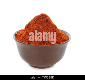 Heap of chili powder in brown pottery bowl isolated on white Stock Photo