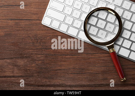 Magnifying glass on keyboard. Internet search concept Stock Photo
