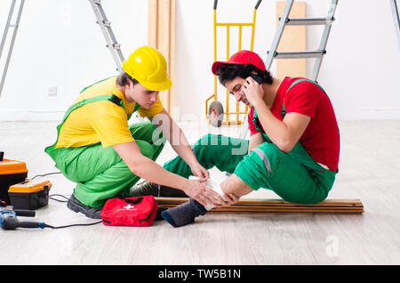 Injured worker and his workmate Stock Photo