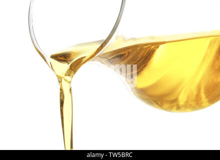 Pouring cooking oil from glass jug, isolated on white Stock Photo