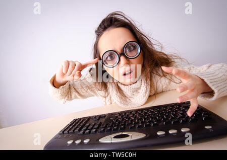 Funny nerd girl working on computer Stock Photo