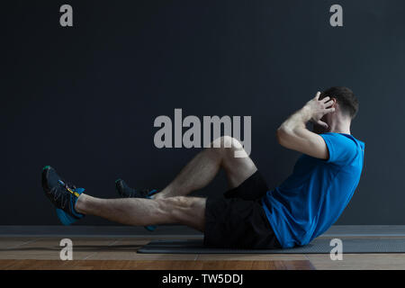 Man doing press exercises. Man oing abdominal exercises. Stock Photo