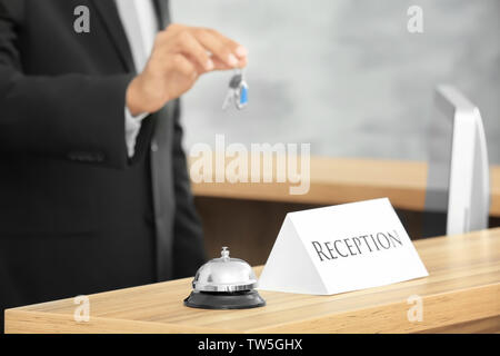 Reception sign with service bell and hotel receptionist on background Stock Photo
