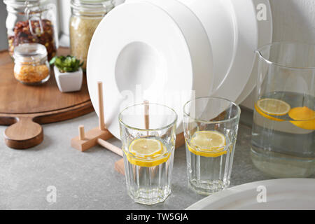 Set of white ceramic plates and fresh lemonade on kitchen counter Stock Photo