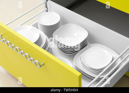 Plates in kitchen drawer Stock Photo