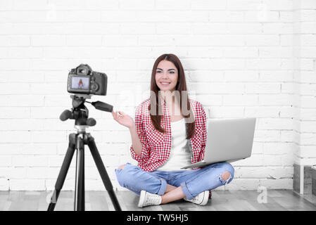 Young woman recording video at home Stock Photo