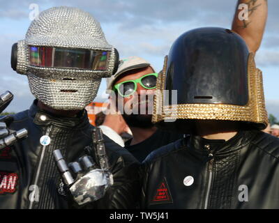 Newport, Isle of Wight. June 16 2019. Isle of Wight Festival - Human Robots duo with biker helmets showing off their attire nouveau costumes. Stock Photo