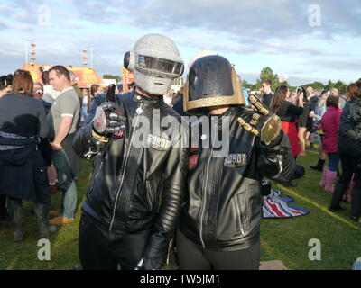 Newport, Isle of Wight. June 16 2019. Isle of Wight Festival - Human Robots duo with biker helmets showing off their attire nouveau costumes. Stock Photo