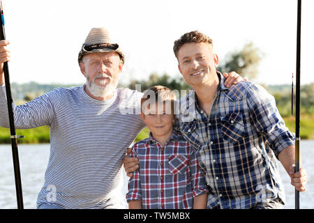 Family fishing on pond together Stock Photo