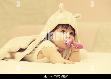 Baby girl playing with toy on blanket at home Stock Photo