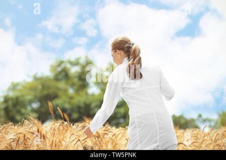 Young agronomist in wheat field Stock Photo