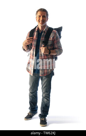 Middle-Aged male tourist with a backpack walking during sunset.  He is isolated on a white background for composites.  It depicts healthy lifestyle ac Stock Photo