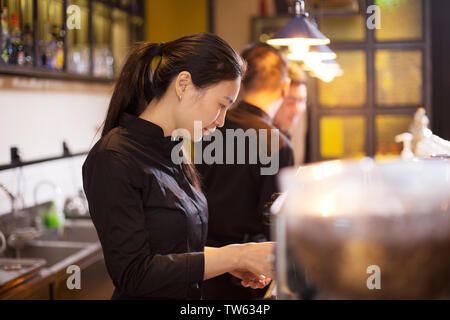 waitress serving in modern cafe Stock Photo