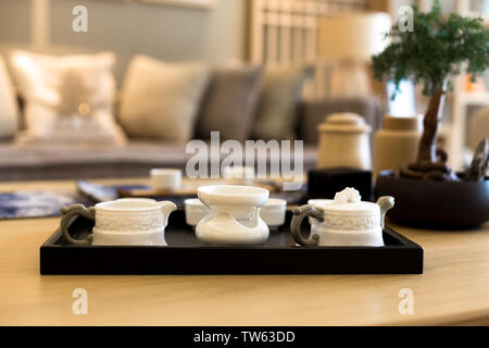 elegant ceramic tea sets on table in modern living room Stock Photo