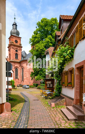 Narrow street with view of the church in the old town of Amorbach in Lower Franconia, Bavaria, Germany Stock Photo