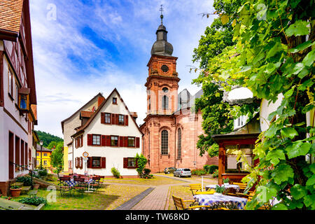 Narrow street with view of the church in the old town of Amorbach in Lower Franconia, Bavaria, Germany Stock Photo