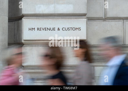 Pedestrians walk past the entrance to the HMRC (Her Majesty's Revenue and Customs) offices in London. Stock Photo