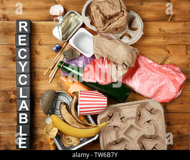 Composition with garbage and word Recyclable on wooden background Stock Photo