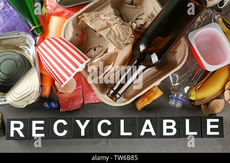 Composition with garbage and word Recyclable on grey background Stock Photo