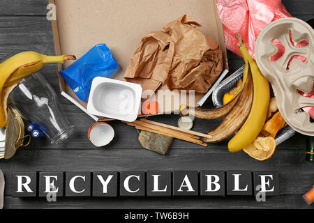 Composition with garbage and word Recyclable on wooden background Stock Photo