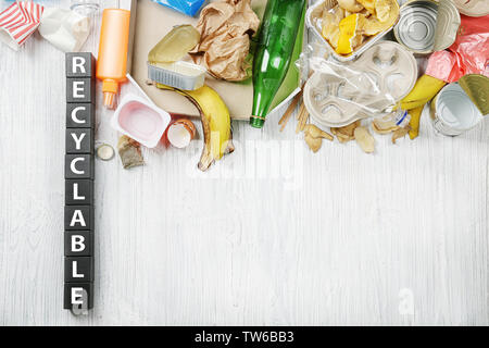 Composition with garbage and word Recyclable on wooden background Stock Photo