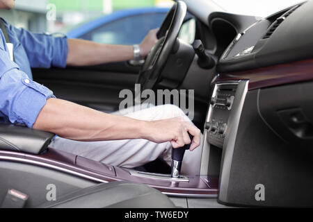 Driver's hand on gear lever Stock Photo