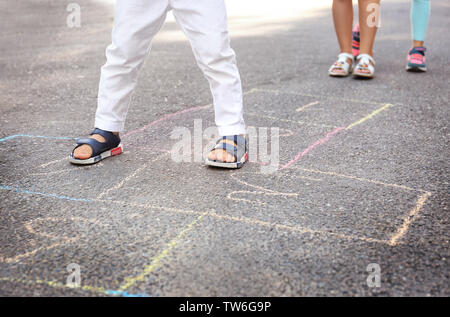 Children playing hopscotch outdoors Stock Photo