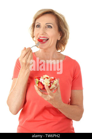 Elderly woman with bowl of fruit salad, isolated on white Stock Photo
