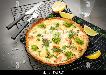 Tasty salmon quiche on cooling rack Stock Photo