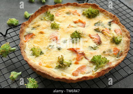 Tasty salmon quiche on cooling rack Stock Photo