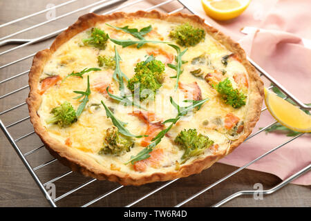 Tasty salmon quiche on cooling rack Stock Photo